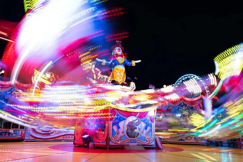 the carnival rides are spinning brightly with lights