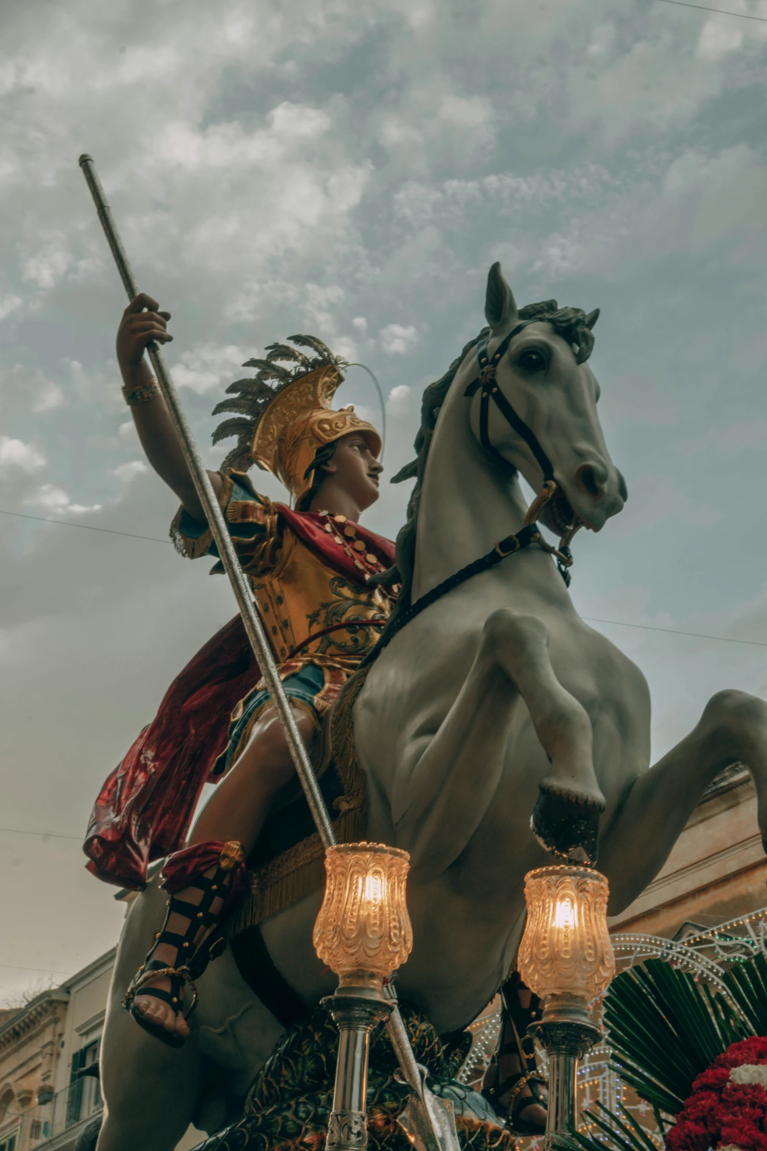 a statue of an indian riding a horse and holding a sword