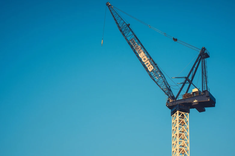 a large crane is attached to a construction site