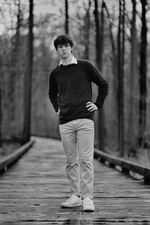 a man standing on a bridge posing for the camera