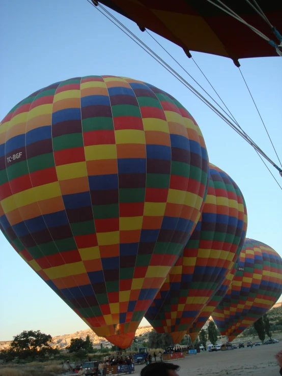 large, brightly colored balloons are flying in the sky