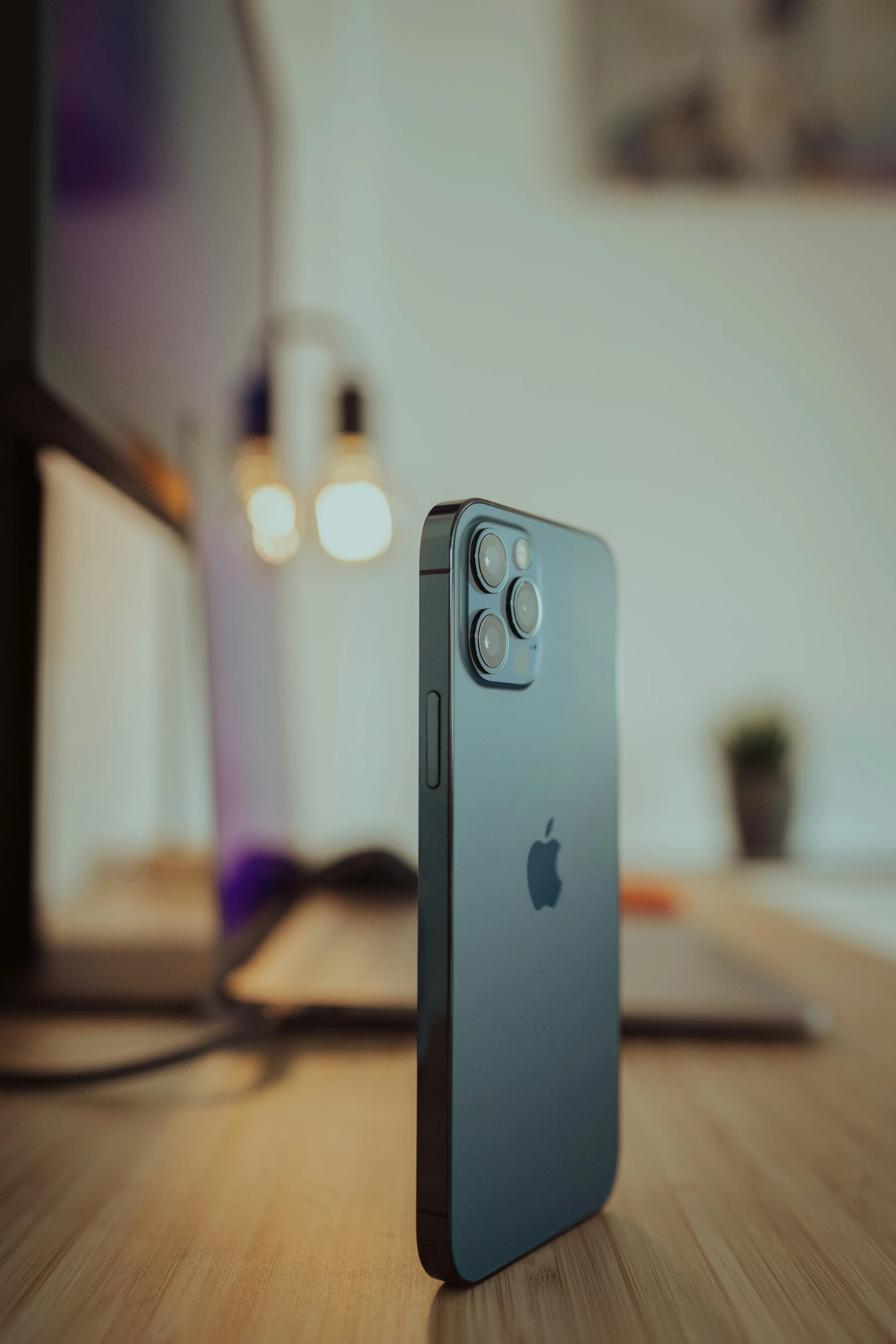 an iphone is seen sitting on top of a wooden table