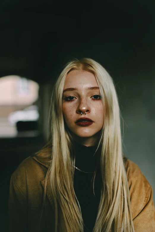 a blonde girl wearing a yellow jacket