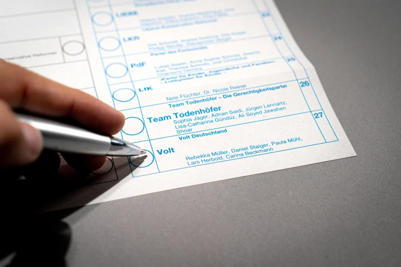 a person holding a pen and working on an exam