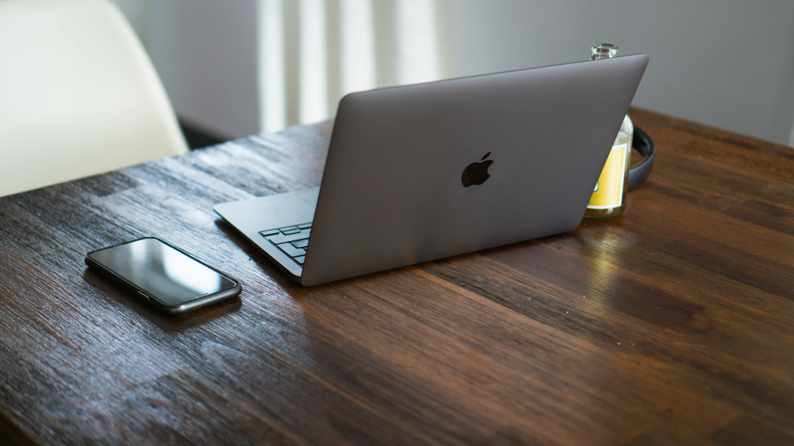 a laptop computer sitting on top of a wooden table