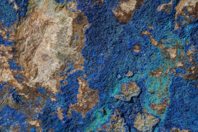 blue, brown and white paint on the side of a rock