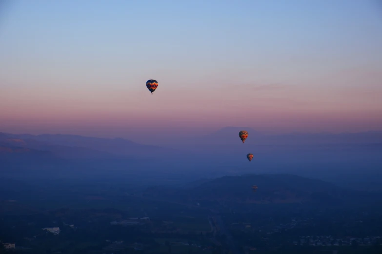 there are two  air balloons flying in the sky