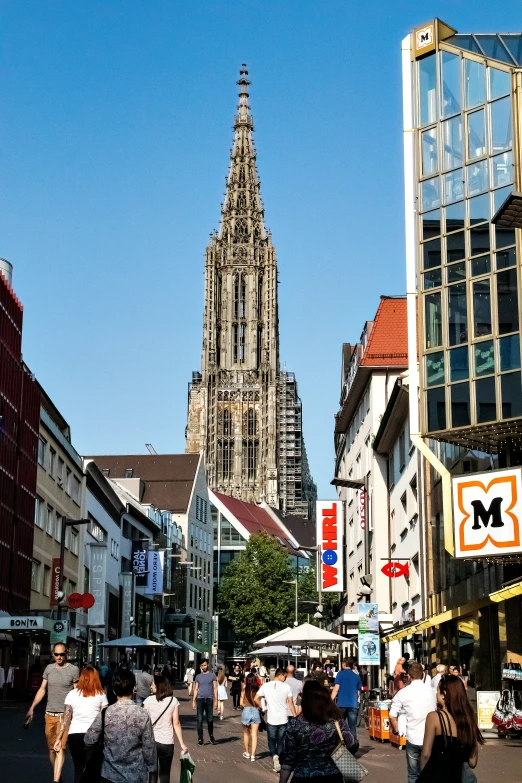 people walk down the street of a european city