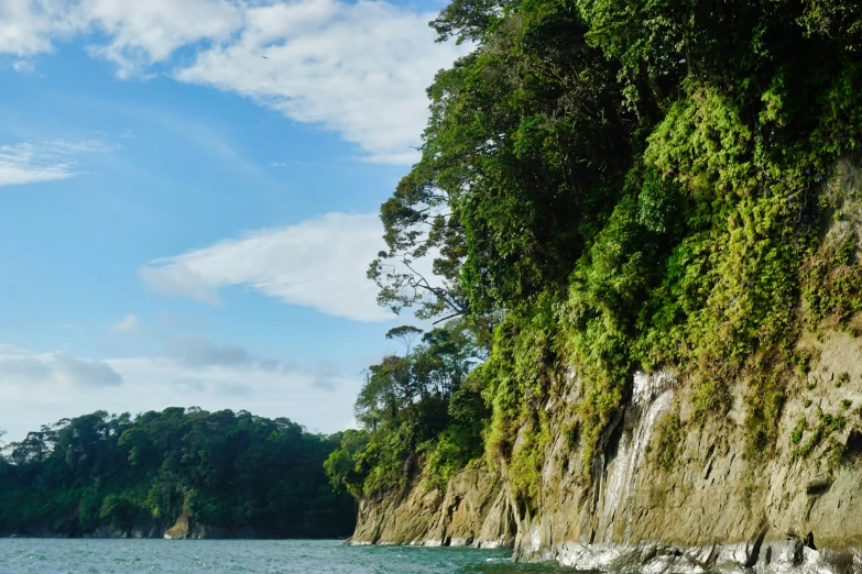 a small boat in the water near large rocks