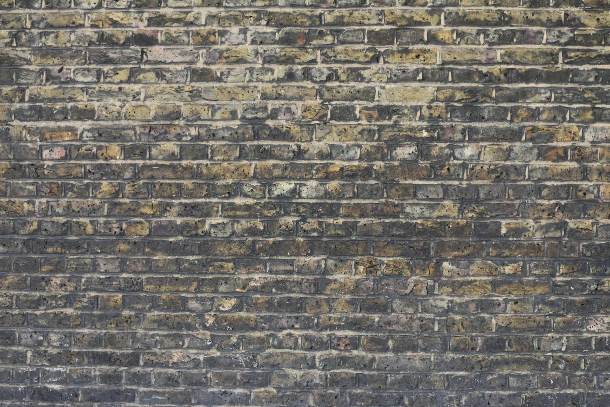 there is a brick wall that has been made with multiple shades of orange and black