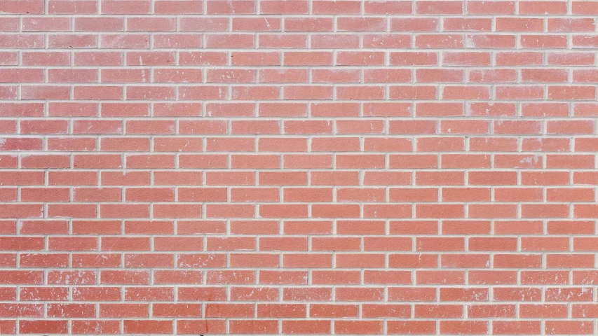 a brick wall with some orange and white paint