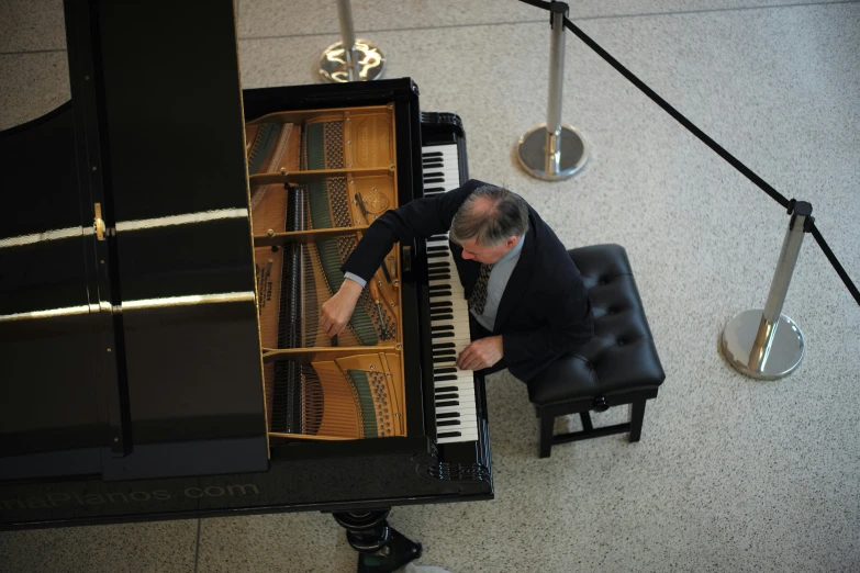 a man sitting at a piano in a room