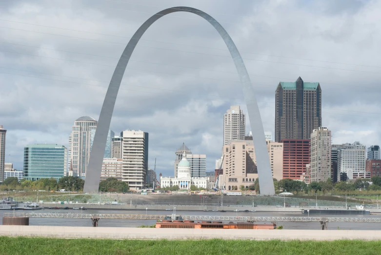 a tall bridge over a river surrounded by tall buildings