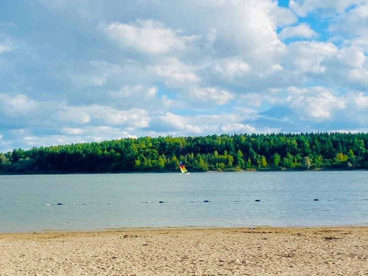 a sandy beach sits next to the water