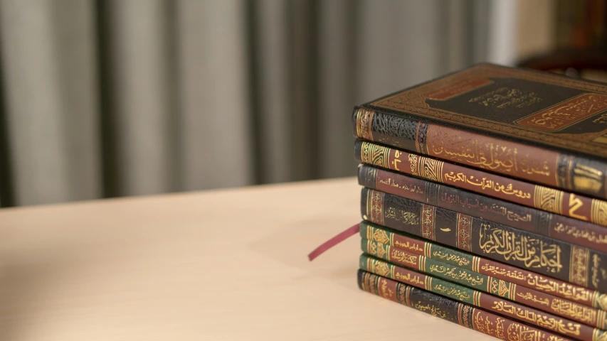 a stack of books sits on a table