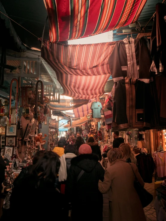 a crowded market with many people walking around