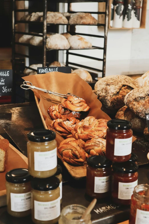 an assortment of bread and jams on display for sale