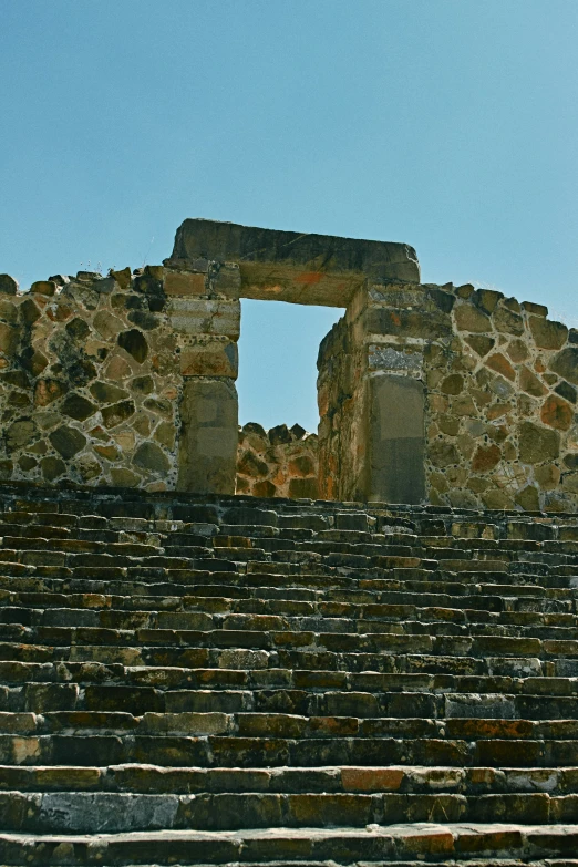 an old, stone - built building sits in front of a clear blue sky