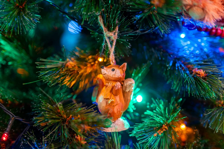 a cat ornament on a tree in the holiday ornament