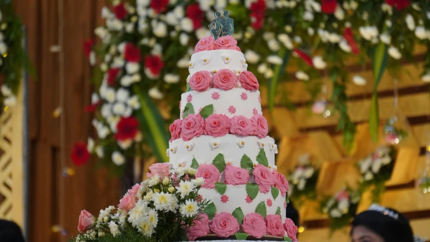 the three tiered cake has pink flowers