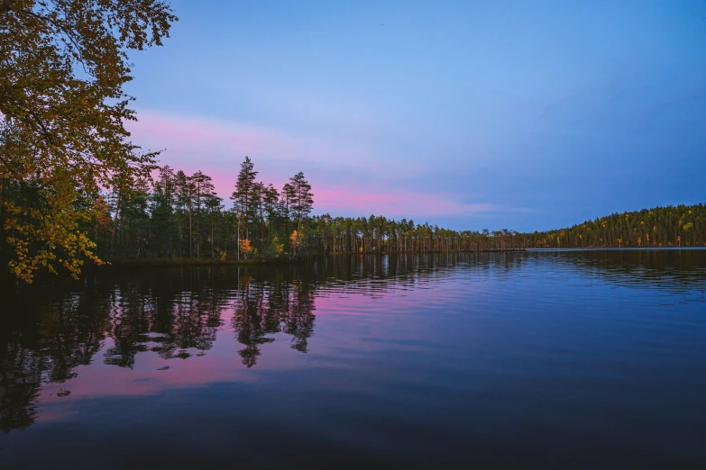 there is a beautiful blue lake and trees