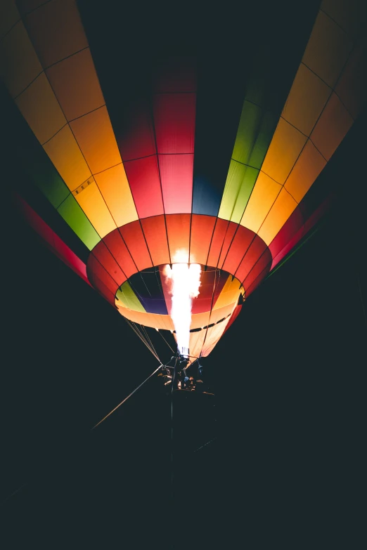 brightly lit  air balloons flying at night