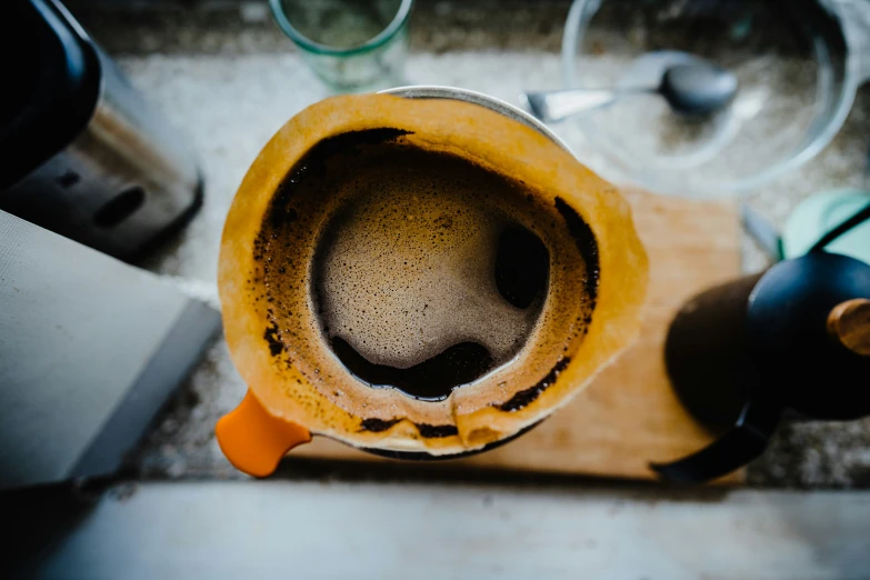 a dirty coffee maker left on a kitchen counter