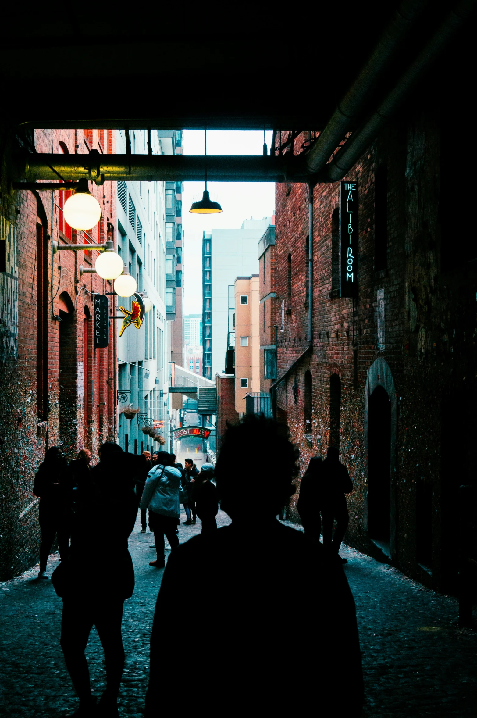 a silhouette is seen walking down an alley in the city