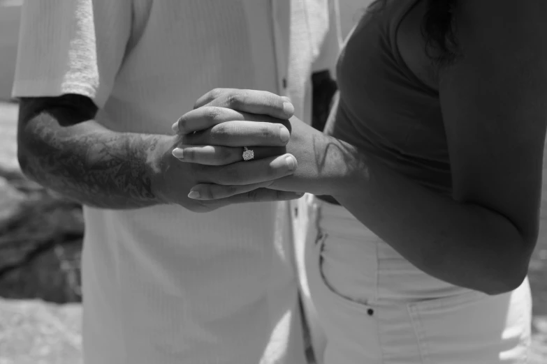 a close up of a person holding the other hand