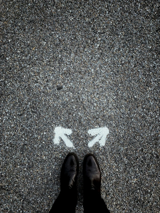 the person stands on the edge of a street