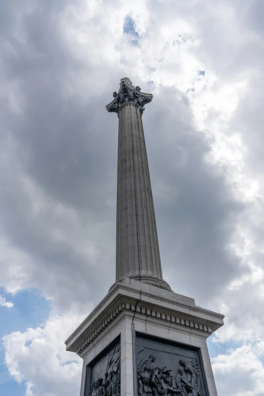 the monument sits under a gray sky with some clouds