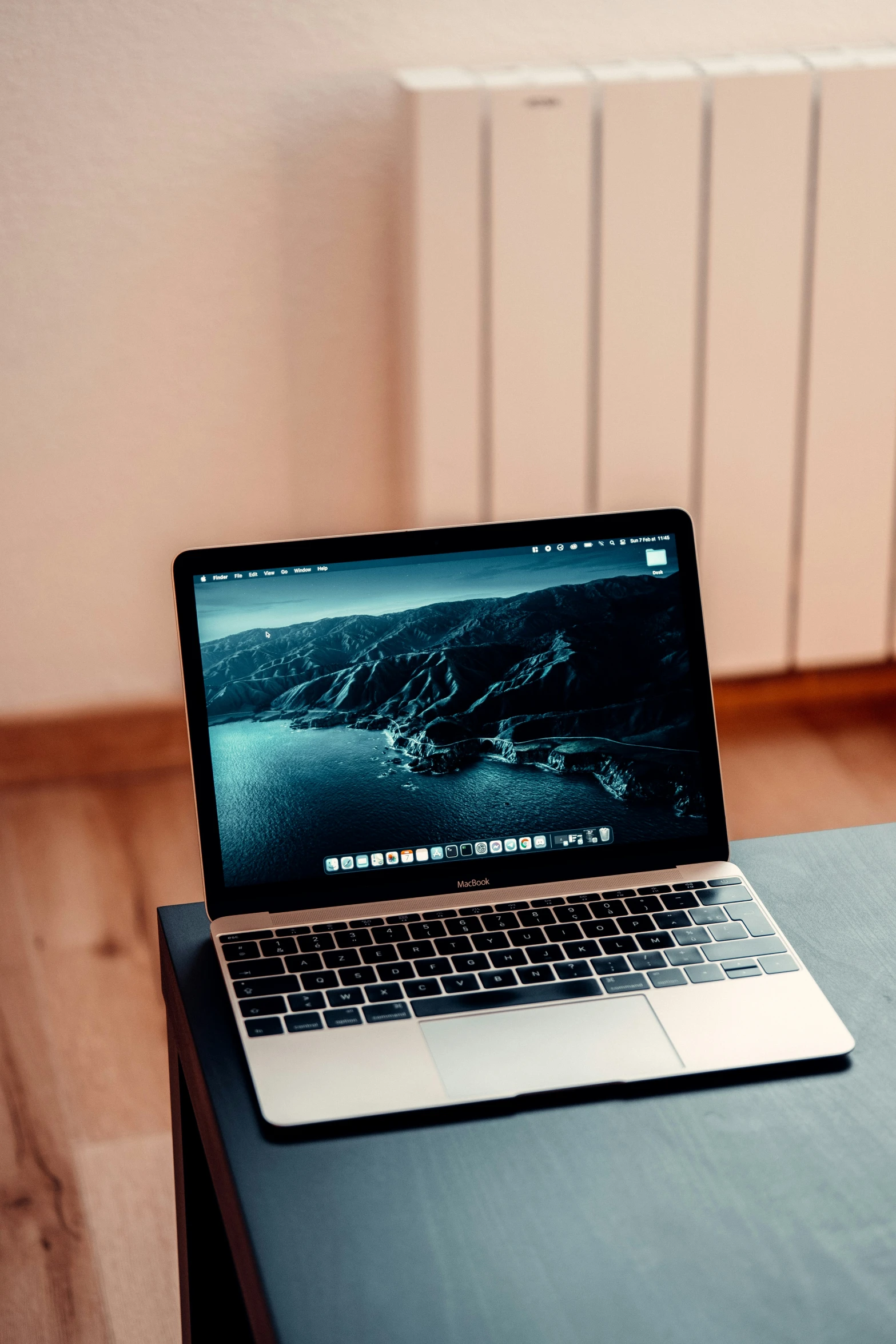 a laptop sitting on a table with the image of the ocean visible