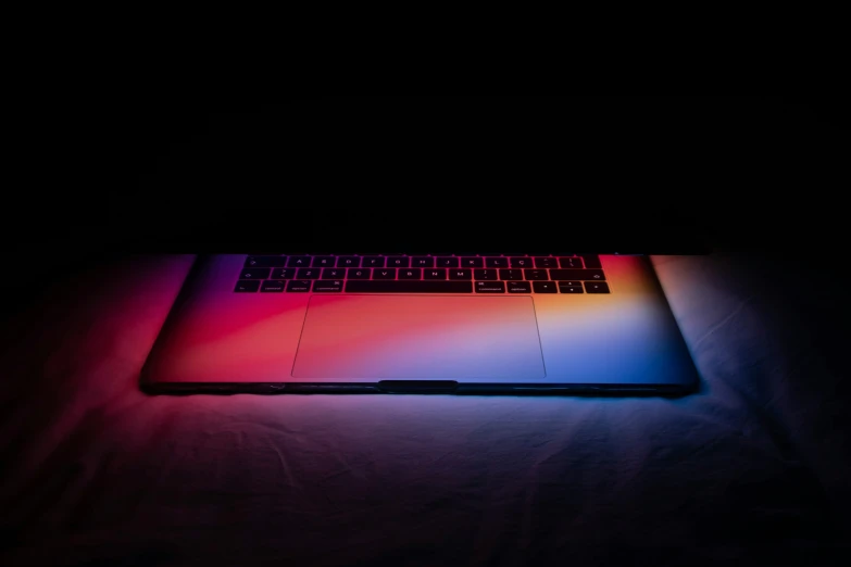 a laptop lit up with its key board glowing red