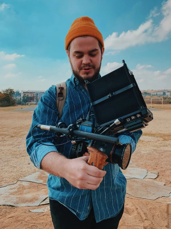 a man carrying a camera and some kind of case