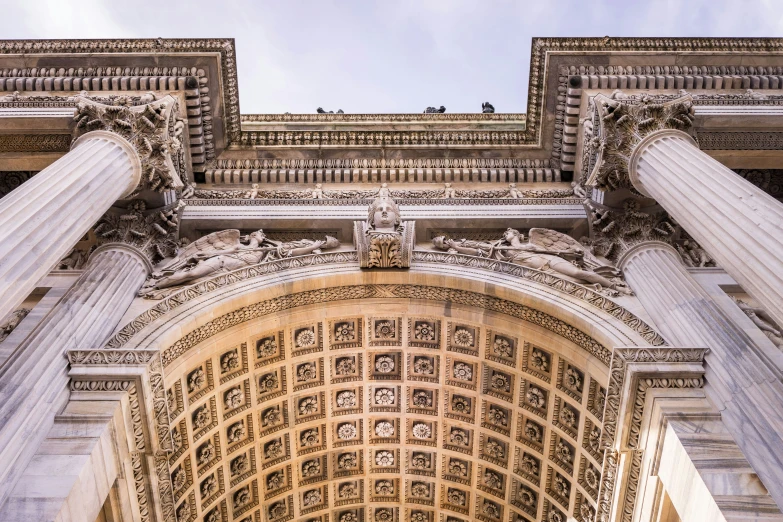 a tall arch with statues and columns on it