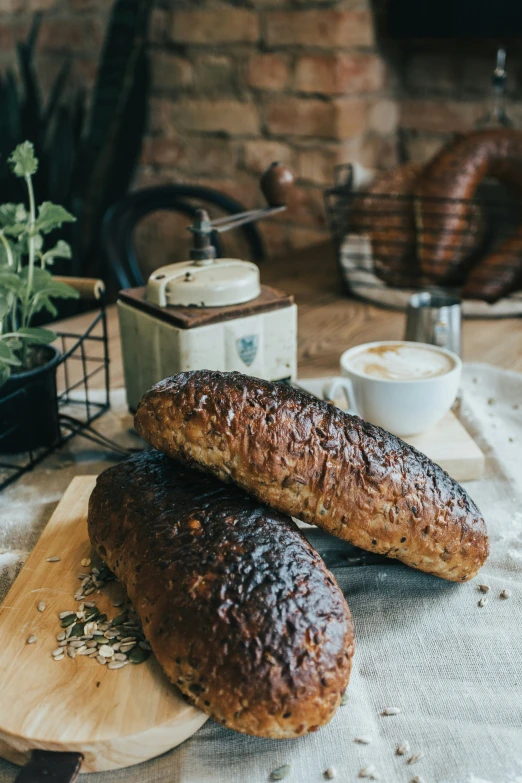 two loaves sitting on top of a wooden  board