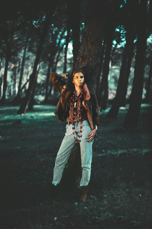 a woman standing in the woods with a stuffed animal on her back