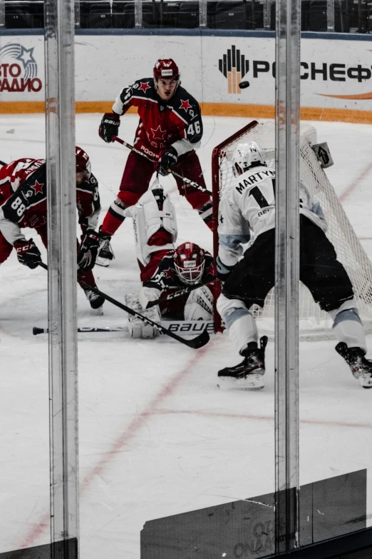 a hockey game in progress, with one player getting ready to block the s
