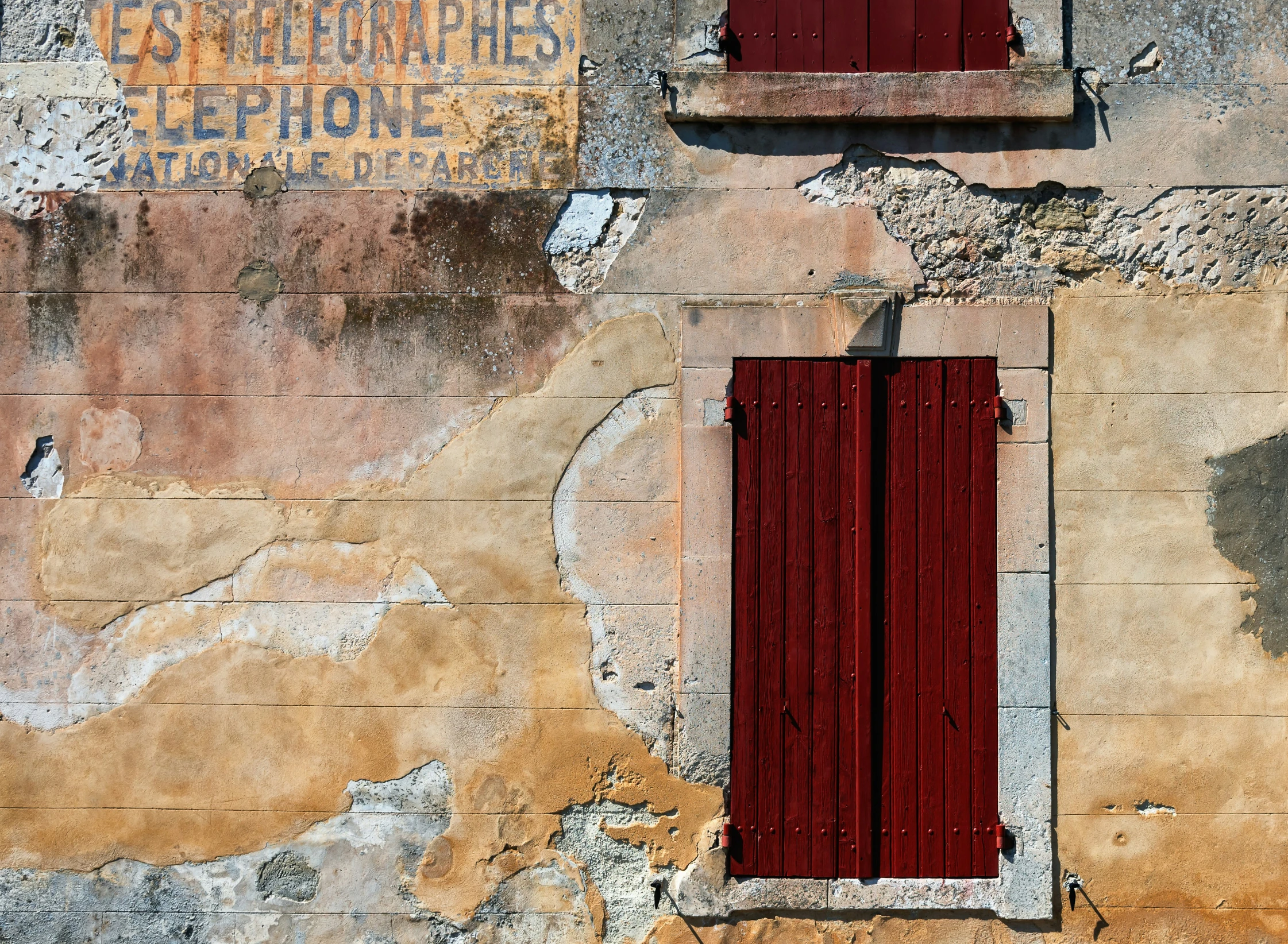 the back side of a building with red shutters