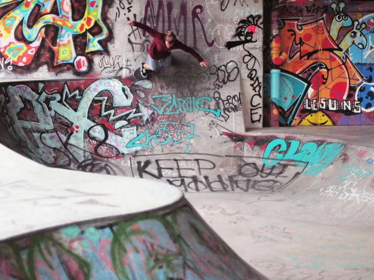 a young man riding a skateboard up the side of a ramp