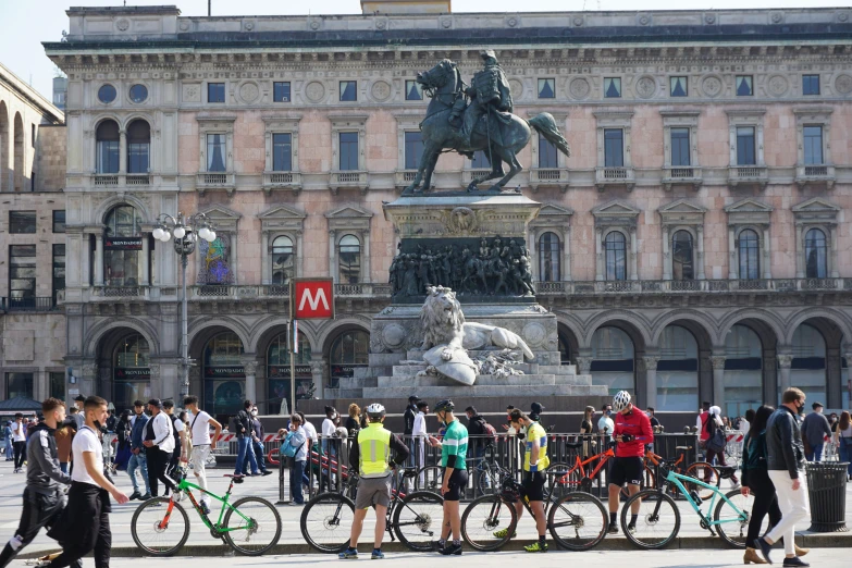 a statue with a person riding a horse near some bicycles