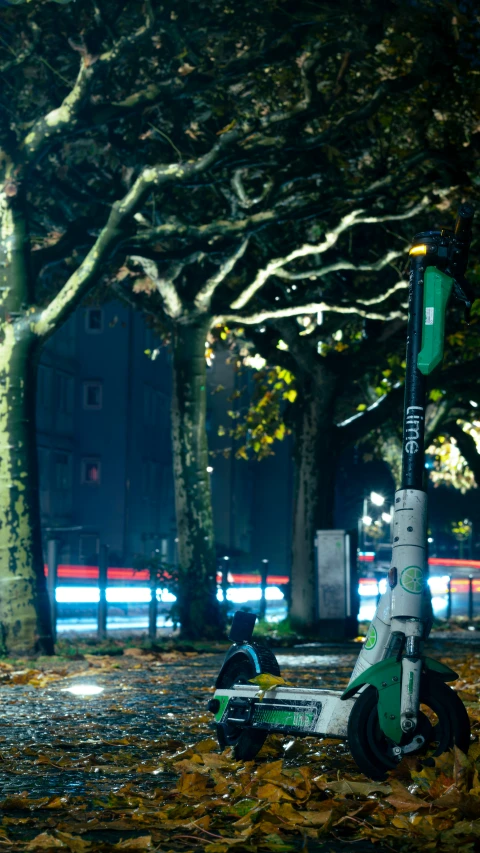 an electric scooter that is parked in the street at night