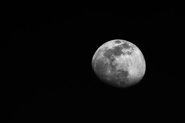 a full moon that is very dark in the night sky