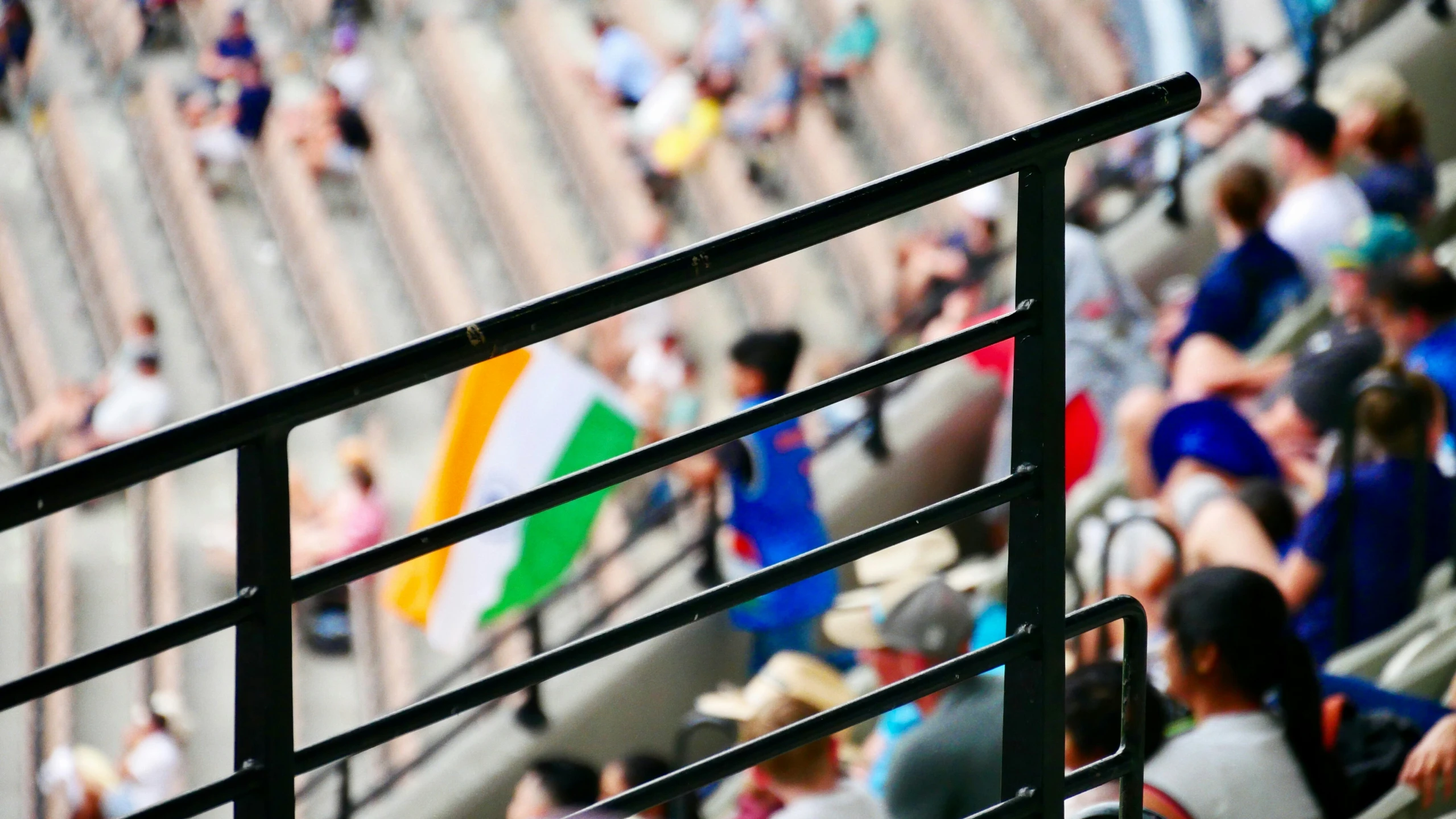 a person with an umbrella standing in front of a crowd of people