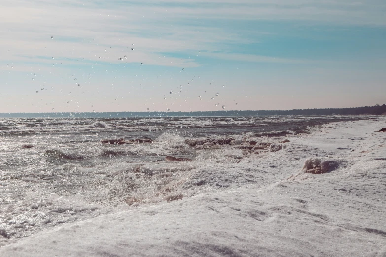 a view of some water with sand on the beach