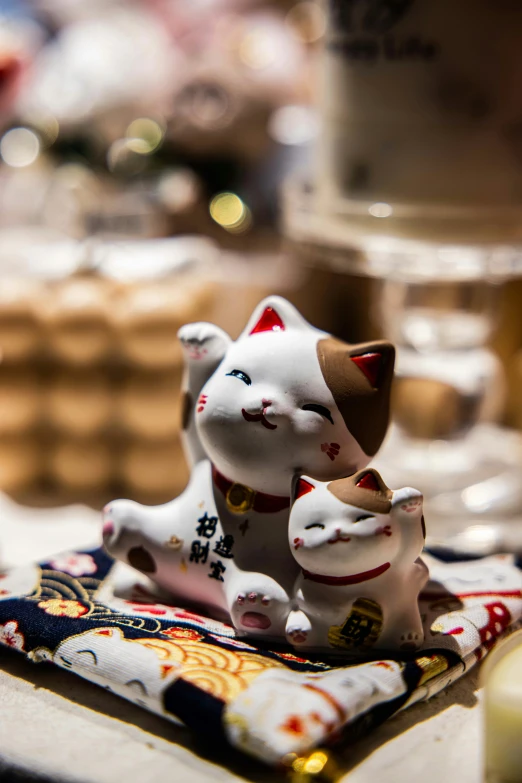 the figurine of two cats sits on the table