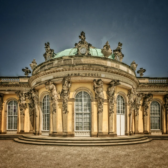 a building with pillars and arches near another building