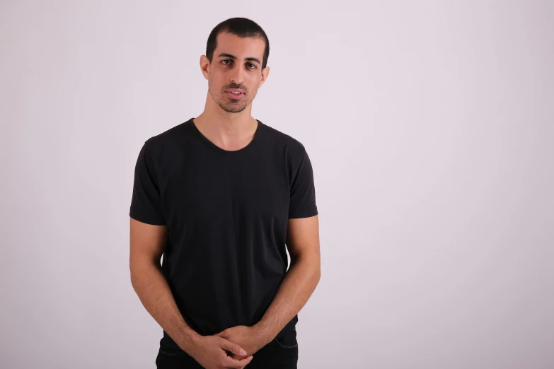 a man posing for a portrait while wearing a black shirt