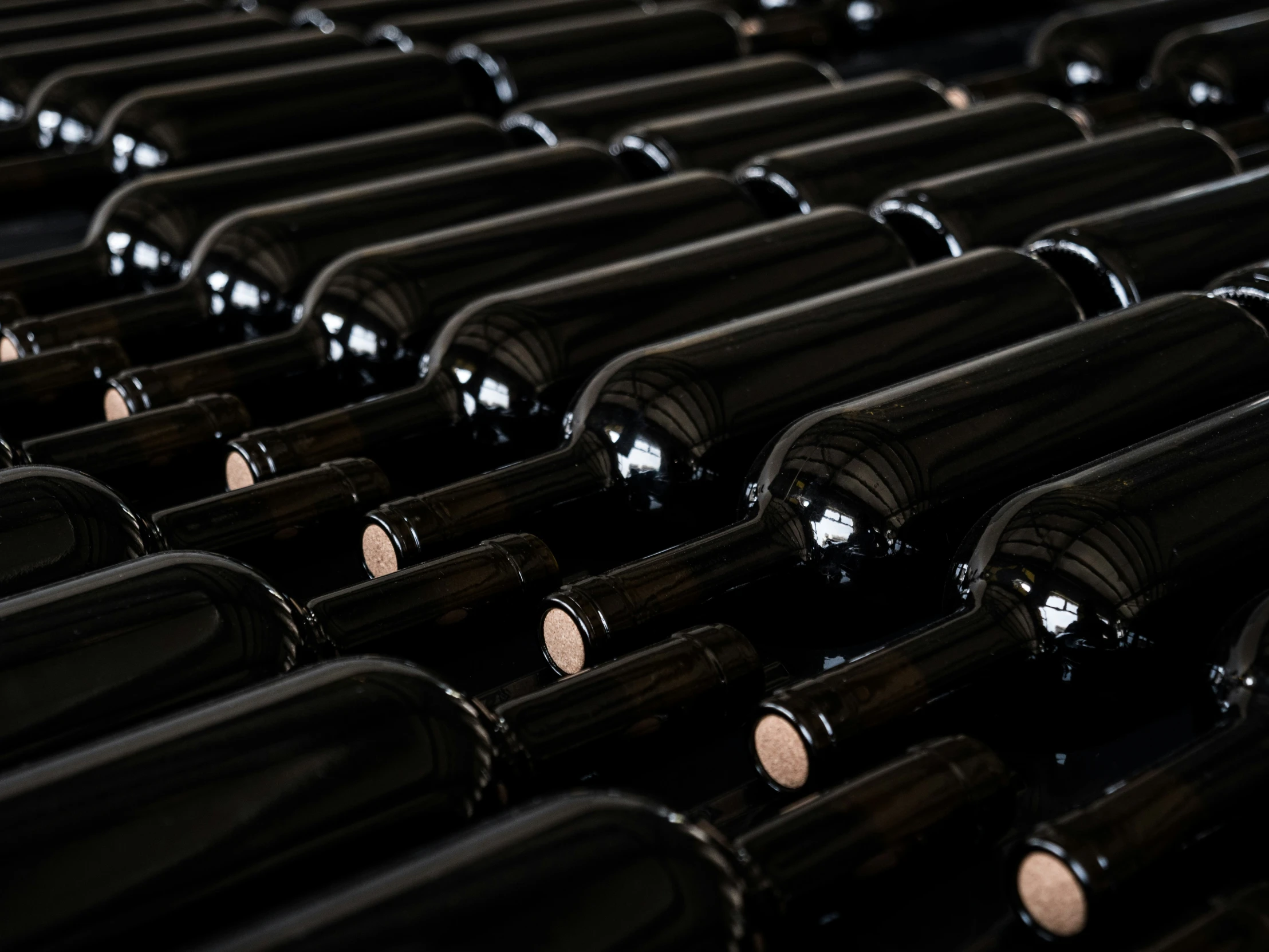 a large number of wine bottles sit empty