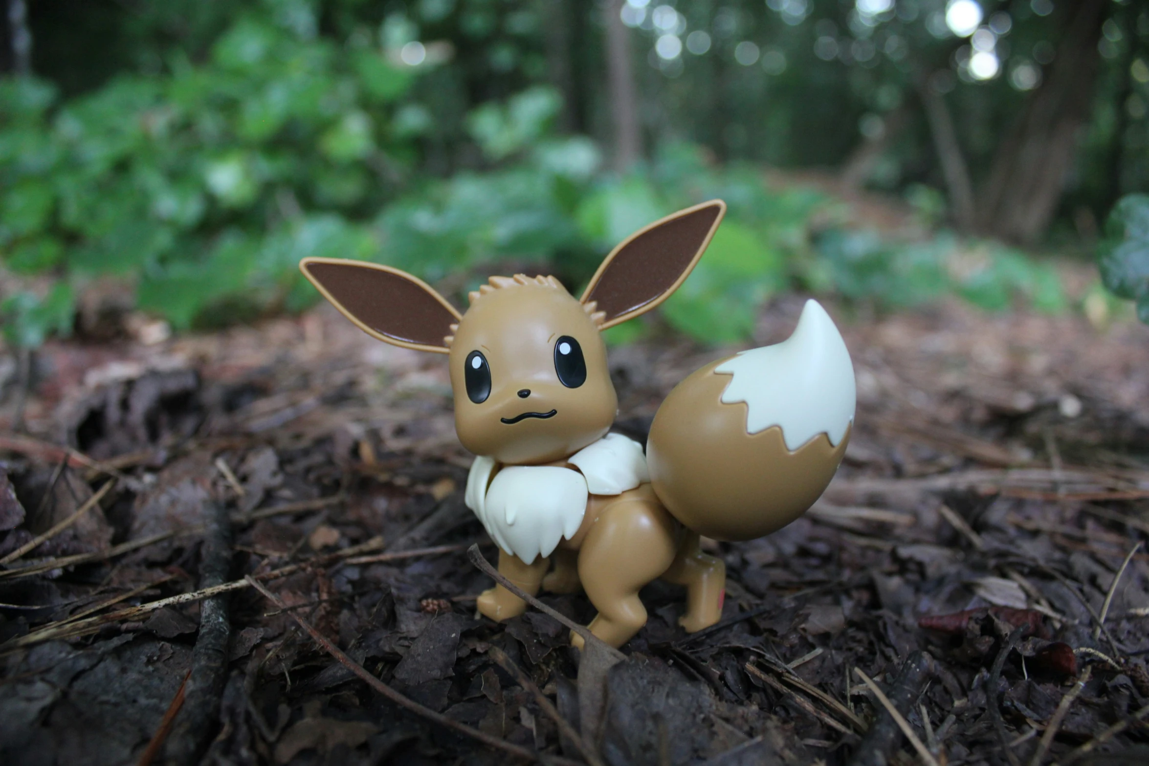 a close up of a pokemon figure standing in the leaves